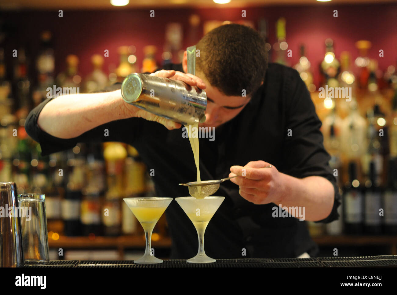 Barman making cocktails at the Twisted lemon cocktail bar and