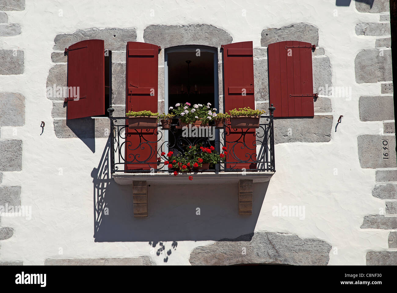 France, Pyrenees, Basque Country, Ainhoa, balcony with flowers Stock Photo