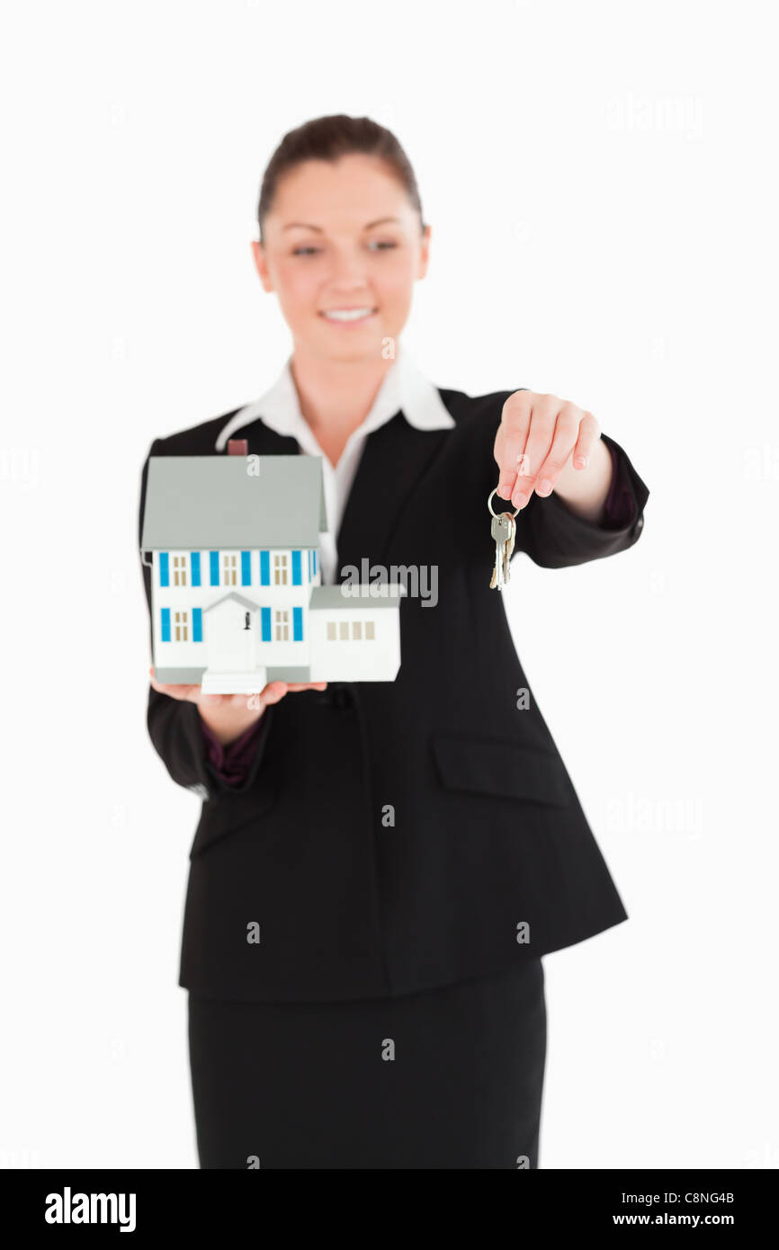 Beautiful woman in suit holding keys and a miniature house Stock Photo ...