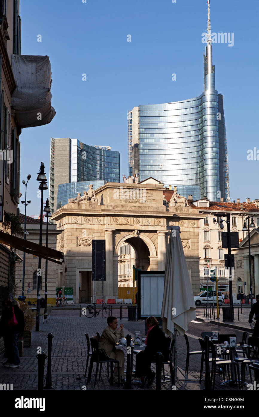 Milano Porta Nuova with the new Province building in the background. Milan, Italy. Two women having a coffee in the street Stock Photo
