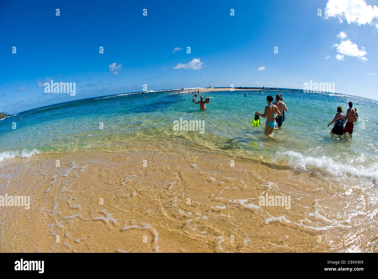 Sunny day at Poipu beach with white sand beach and palm trees, Kauai Stock Photo