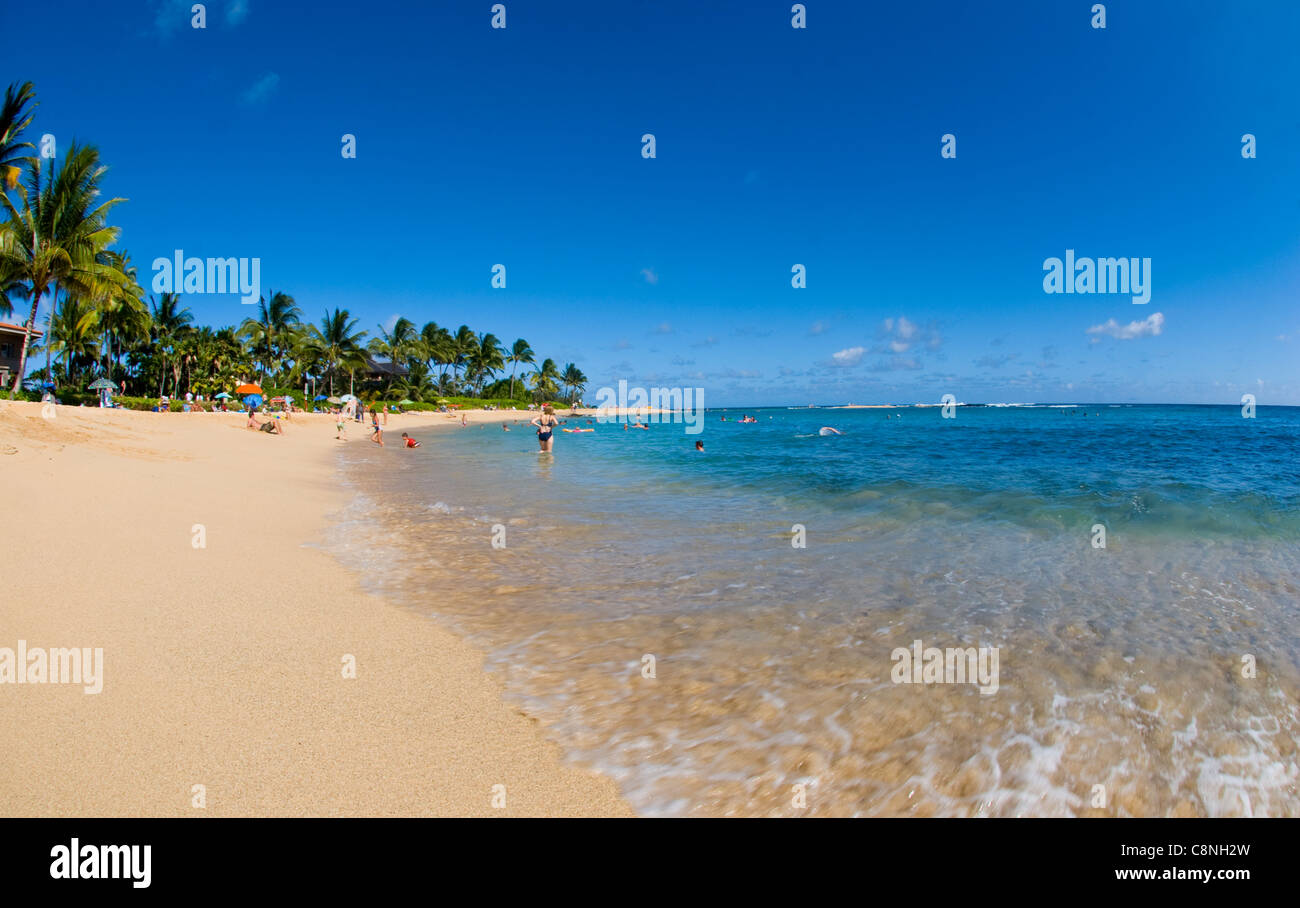 Sunny day at Poipu beach with white sand beach and palm trees, Kauai Stock Photo