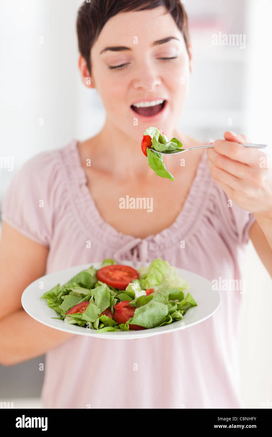 Cheerful woman eating salad Stock Photo Alamy