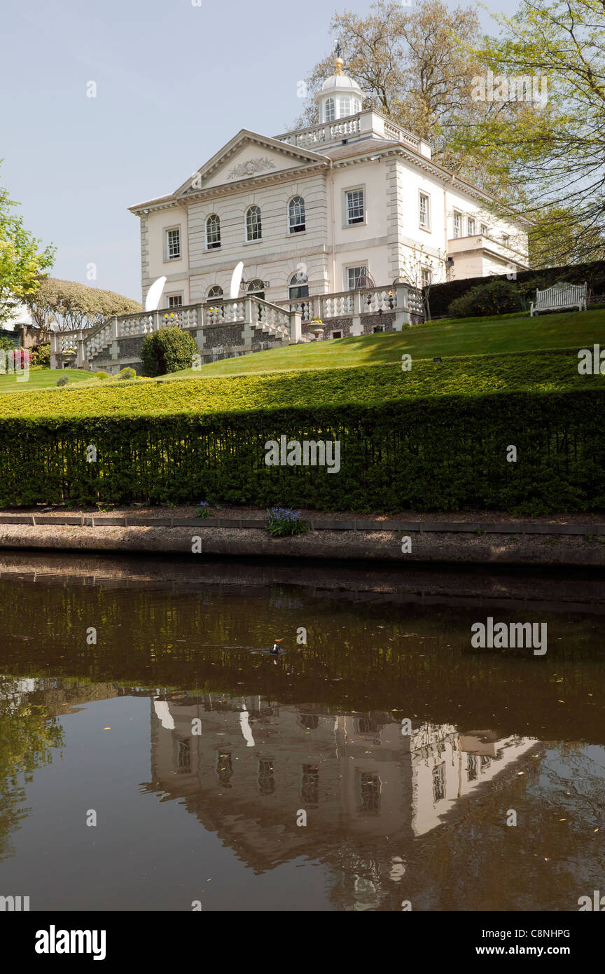 Capture of an imposing Mansion and its reflection in the still waters of the Regents Canal, London. Stock Photo