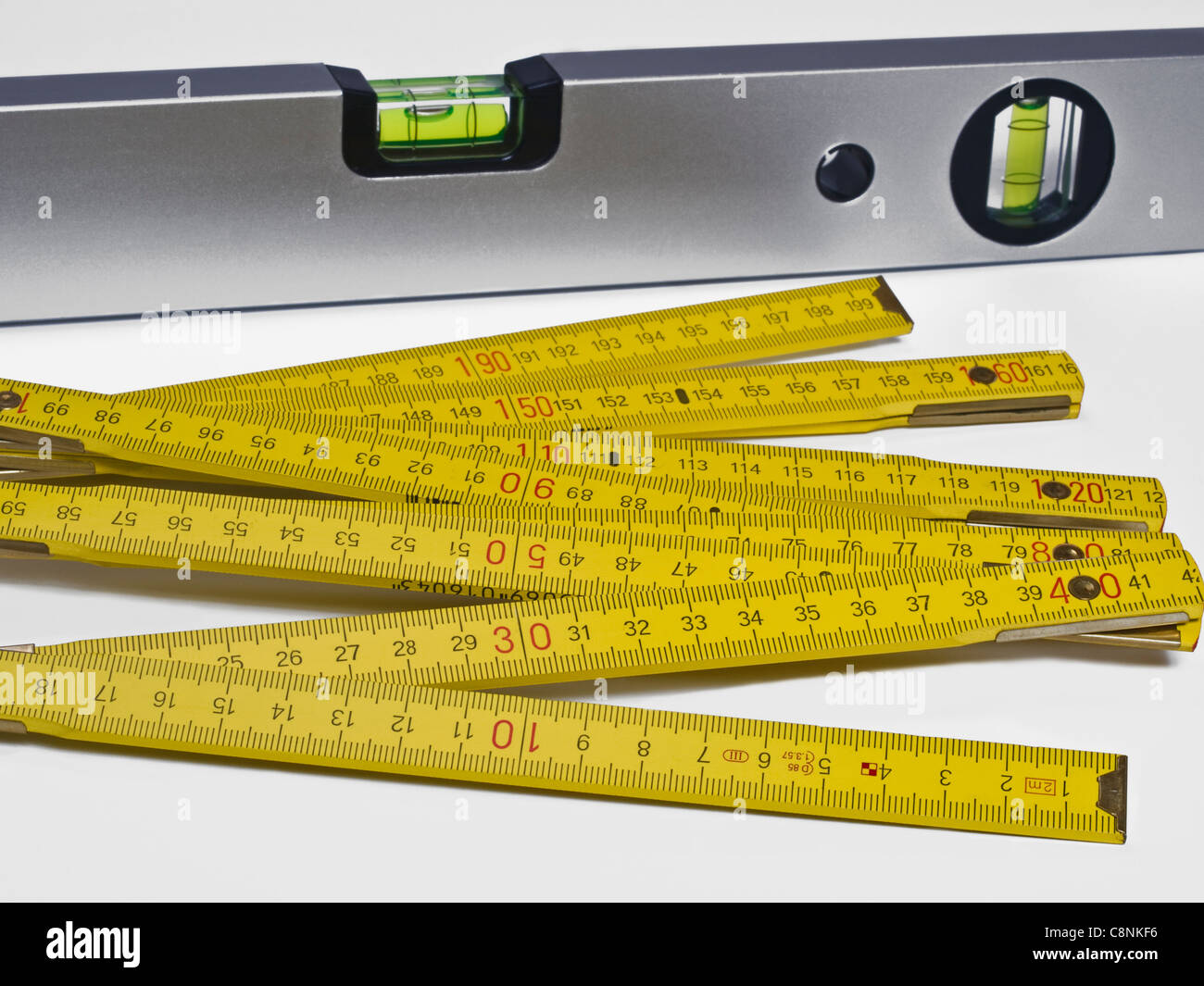 a spirit-level, in front is a folding rule Stock Photo