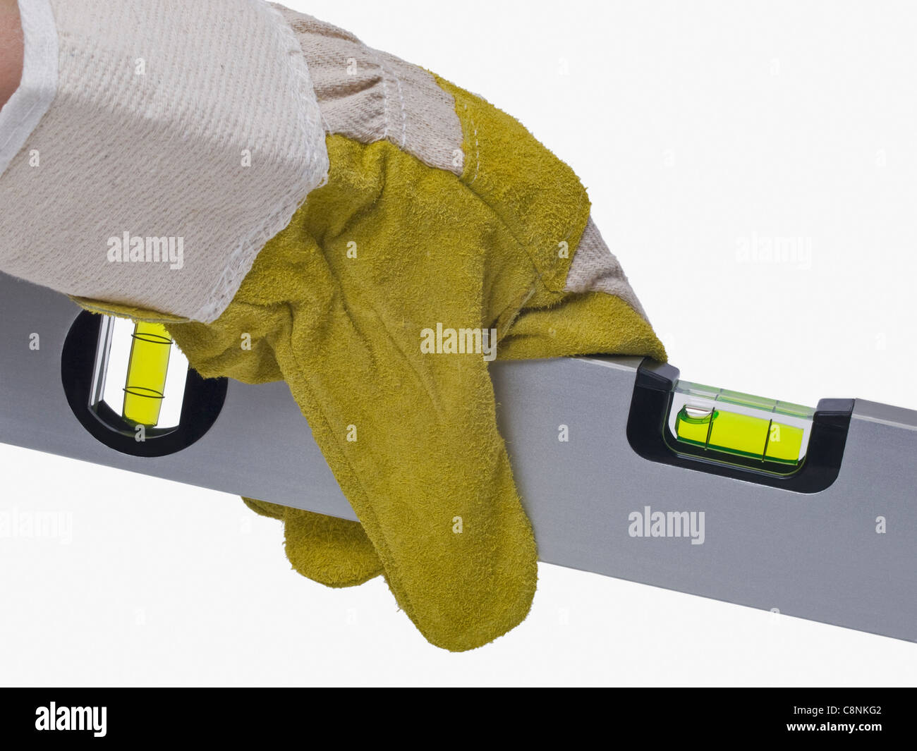 a spirit-level is hand-held with protective gloves Stock Photo