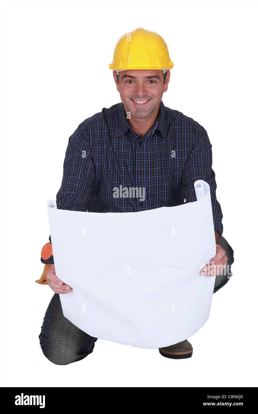 Smiling tradesman looking at a blueprint Stock Photo