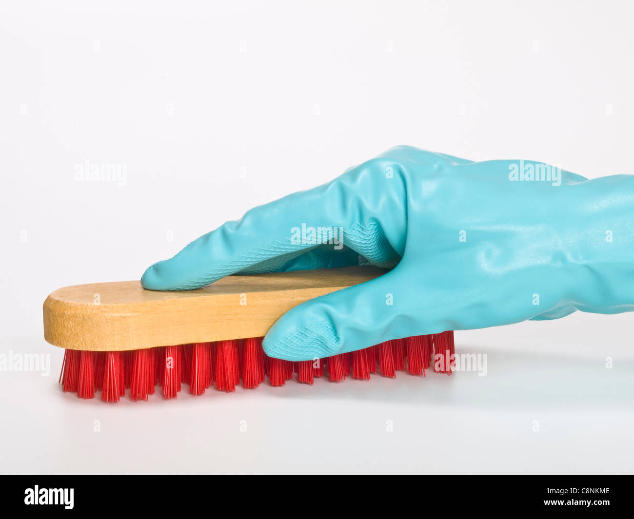 a brush with red bristles is holding with rubber gloves Stock Photo Alamy