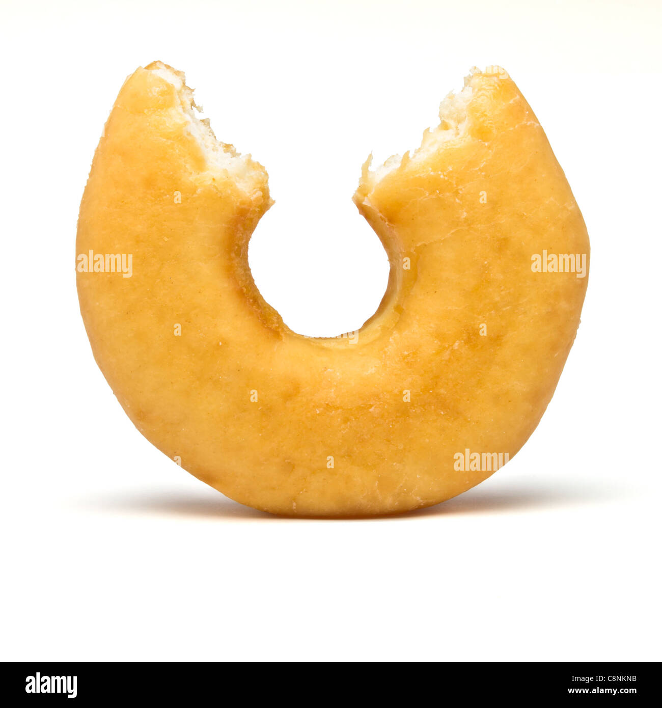 Single donut with bite out from low perspective. Stock Photo