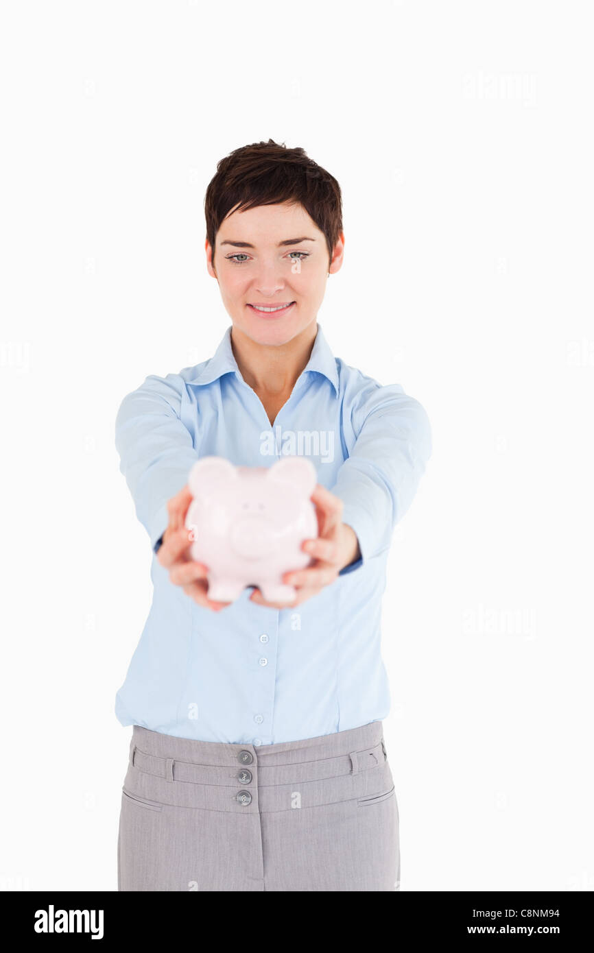 Serious woman holding a piggy bank Stock Photo - Alamy