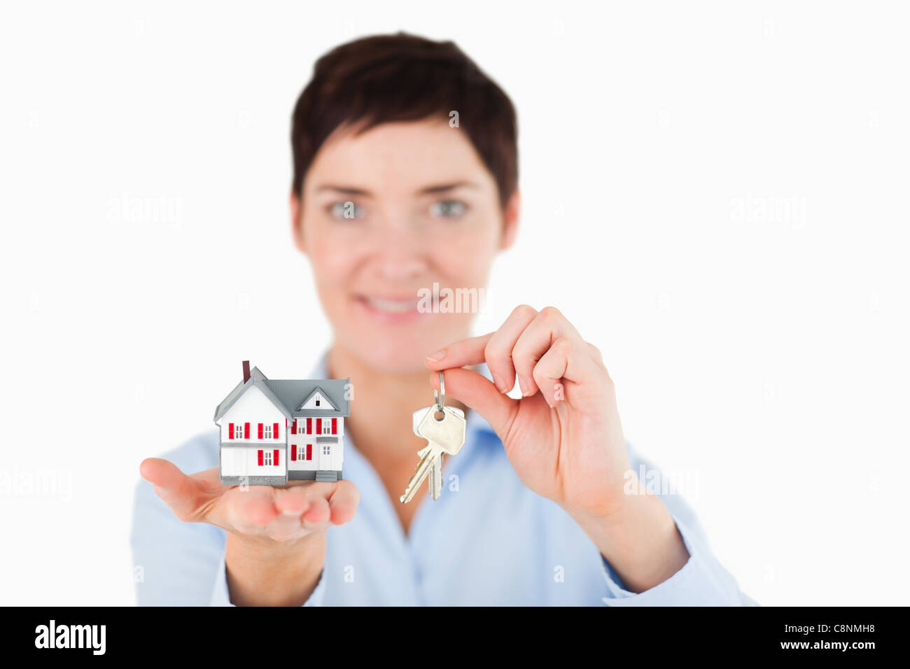 Close up of a woman showing keys and a miniature house Stock Photo - Alamy