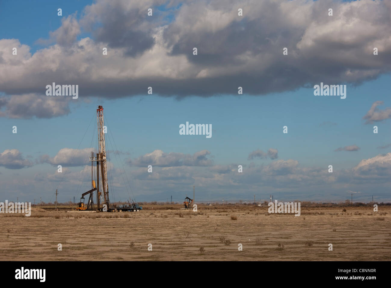 Oil well servicing rig near Bakersfield, California on the floor of the San Joaquin Valley Stock