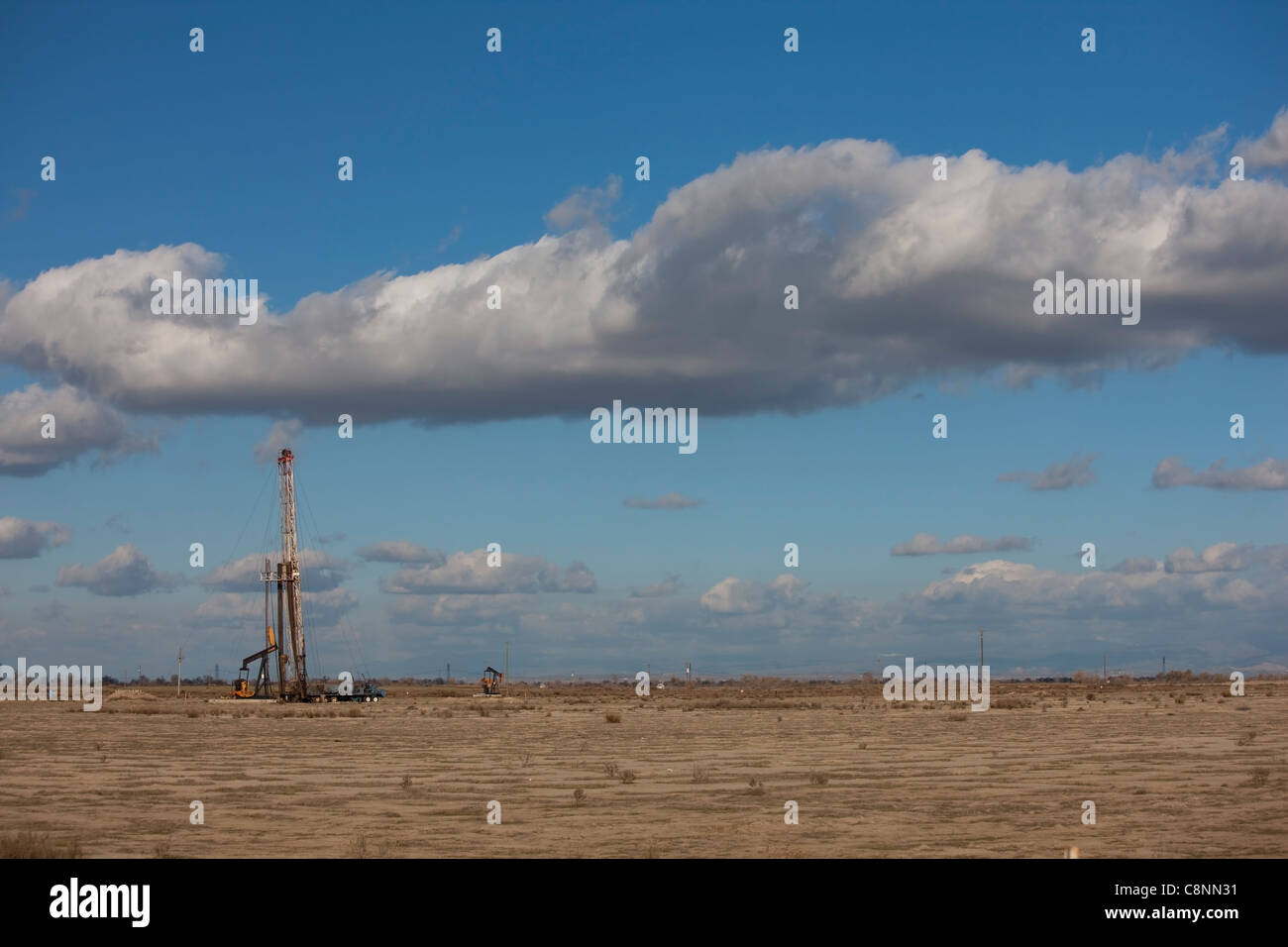 Oil well servicing rig near Bakersfield, California on the floor of the San Joaquin Valley Stock