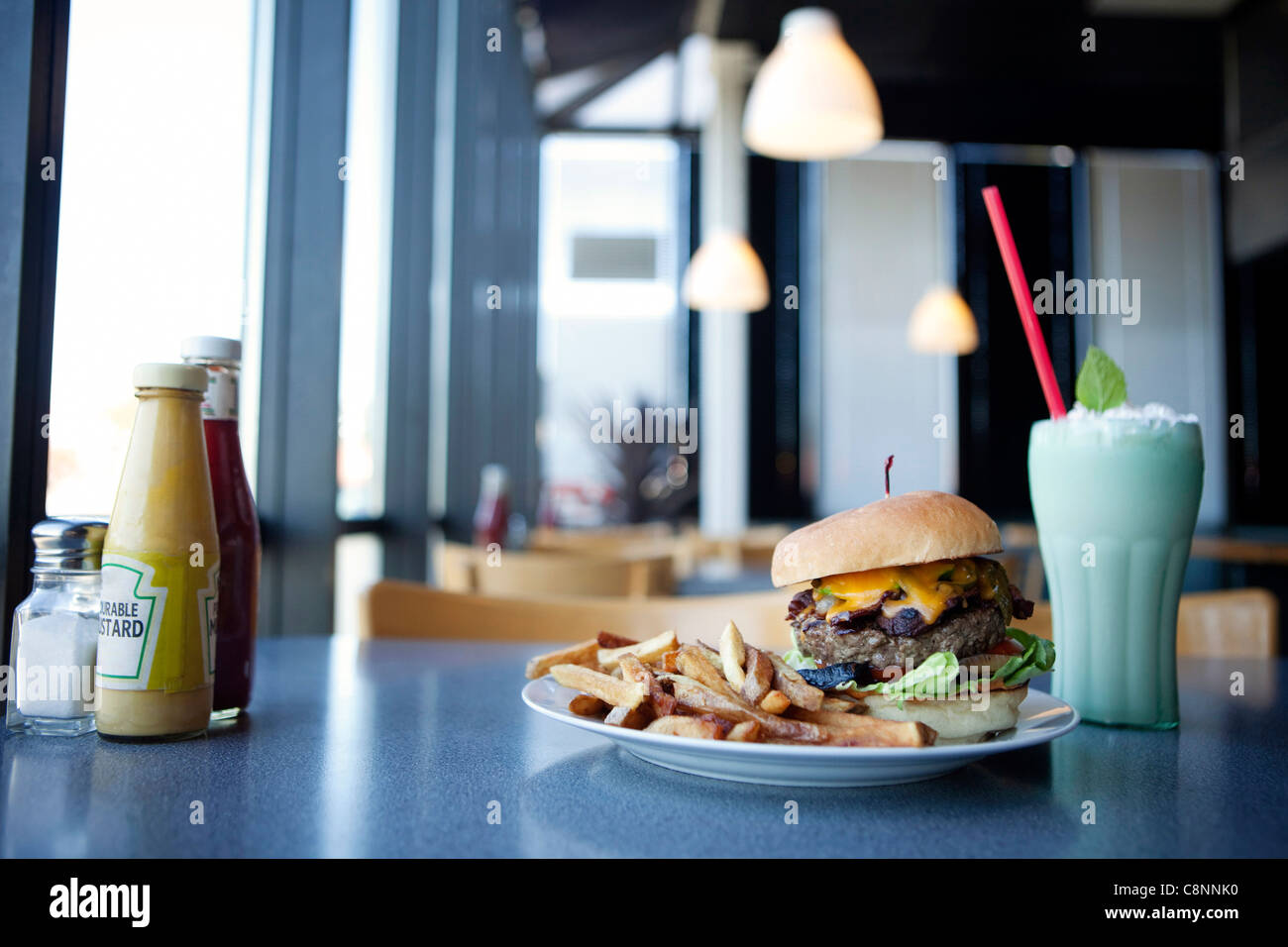 Cheeseburger, french fries and milkshake in diner Stock Photo