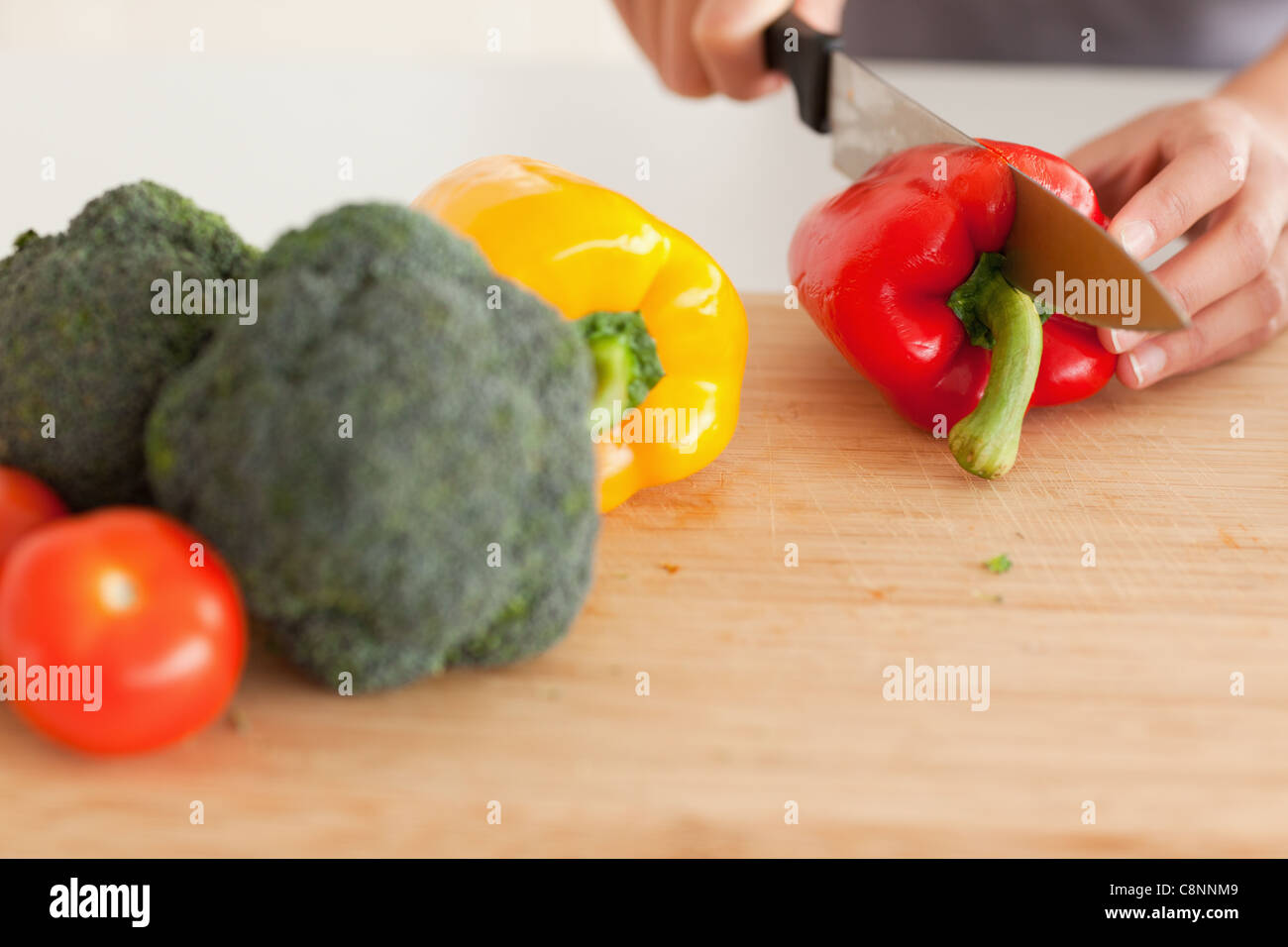 Woman hands cooking vegetables while standing Stock Photo