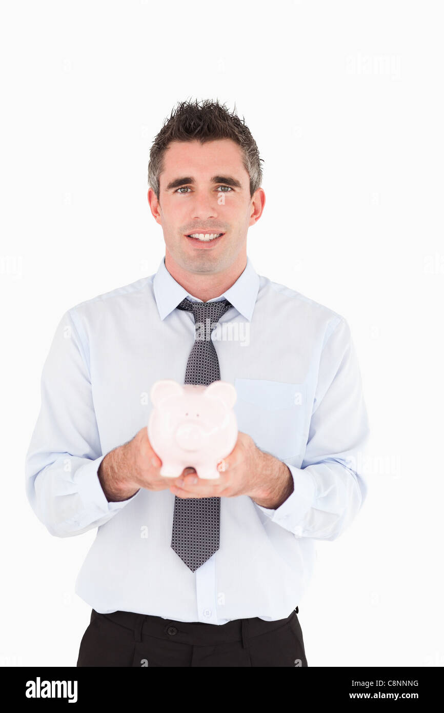 Man showing a piggy bank Stock Photo - Alamy