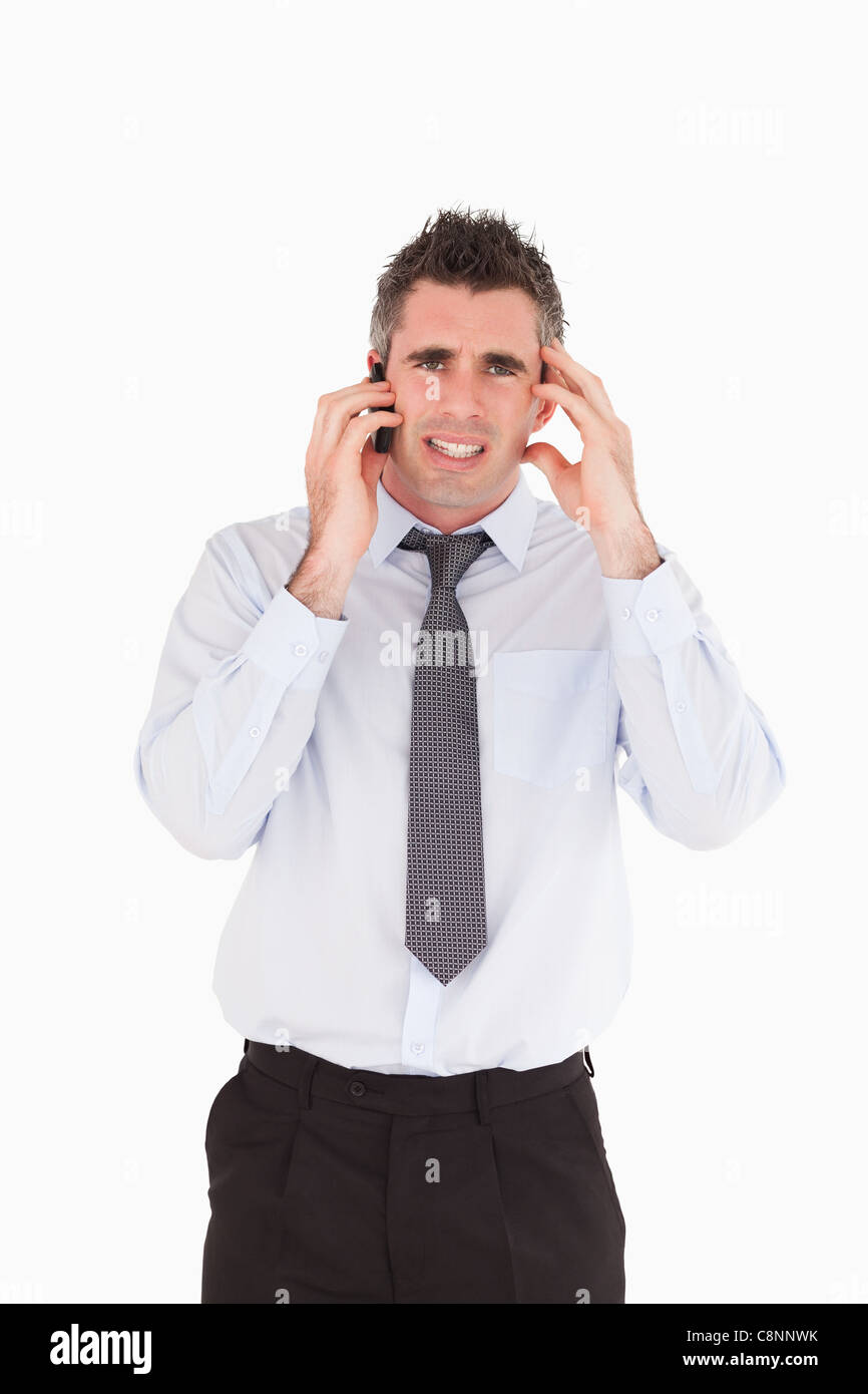 Portrait of an upset man making a phone call Stock Photo - Alamy