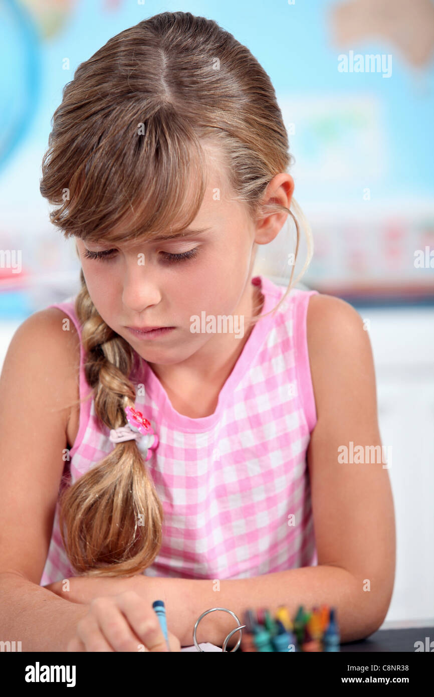 Young girl using wax crayons Stock Photo Alamy