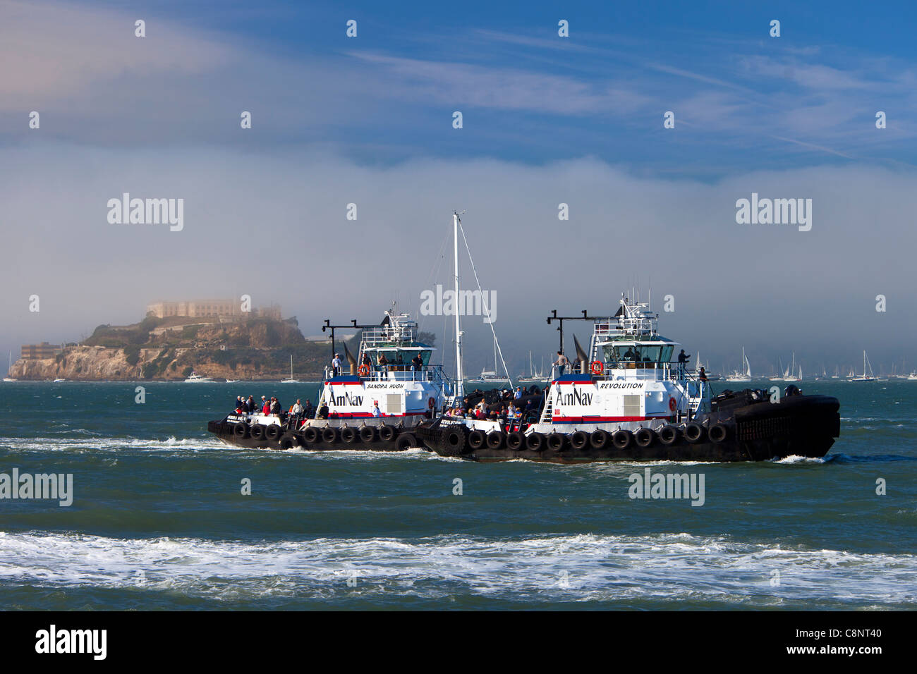 Large tugboats in San Francisco Bay during 'Fleet Week' with Alcatraz Prison beyond, California USA Stock Photo