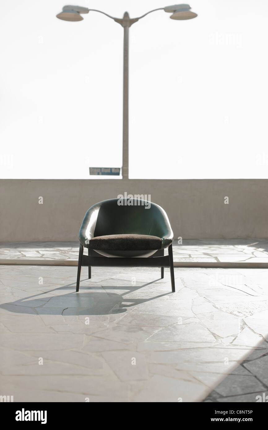 Armchair sitting on rooftop patio Stock Photo