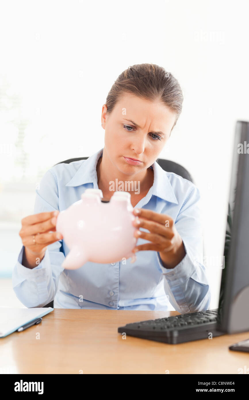 Businesswoman with an empty piggy bank Stock Photo