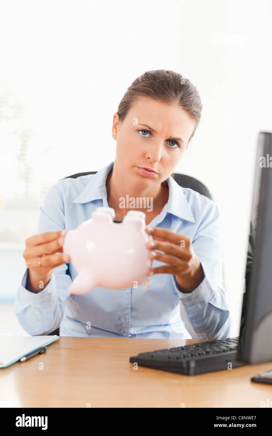 Sad businesswoman with an empty piggy bank Stock Photo - Alamy