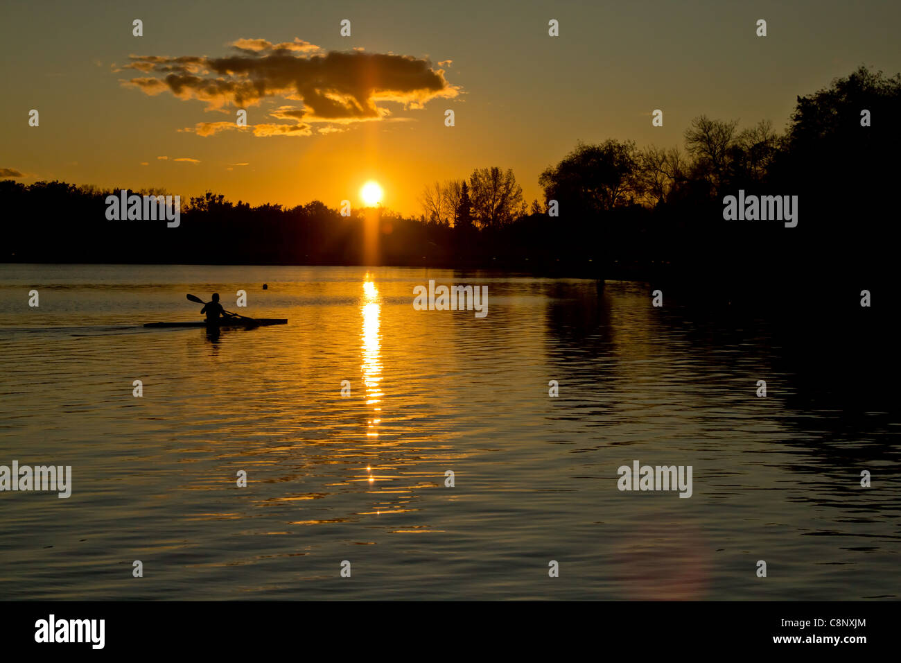 Beautiful sunset over lake Wascana with reflection of the sun on the water Stock Photo