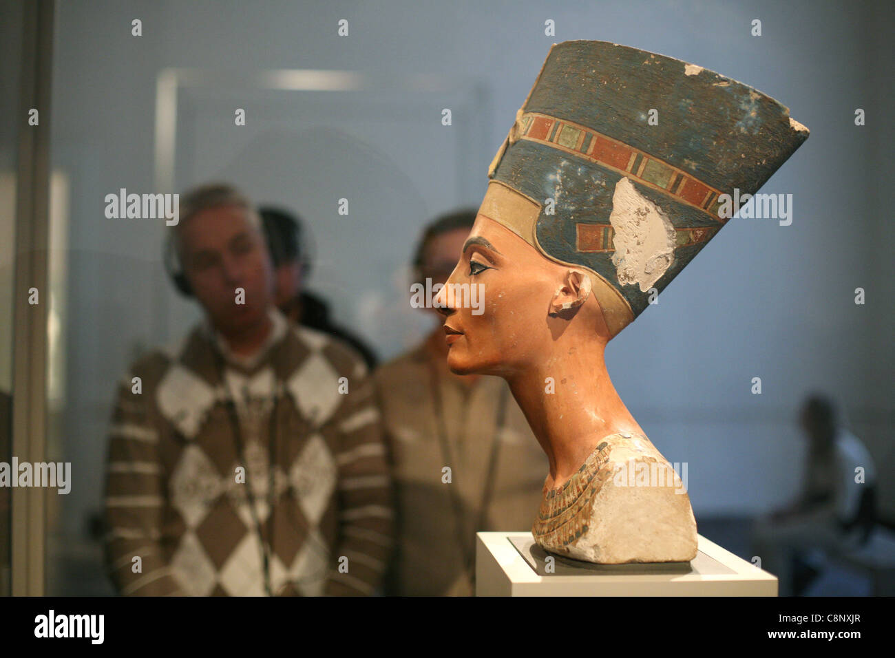 Visitors look at the famous bust of Queen Nefertiti in the Egyptian