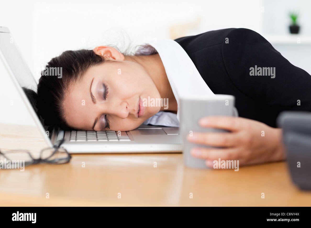 Exhausted businesswoman sleeping at workplace Stock Photo - Alamy