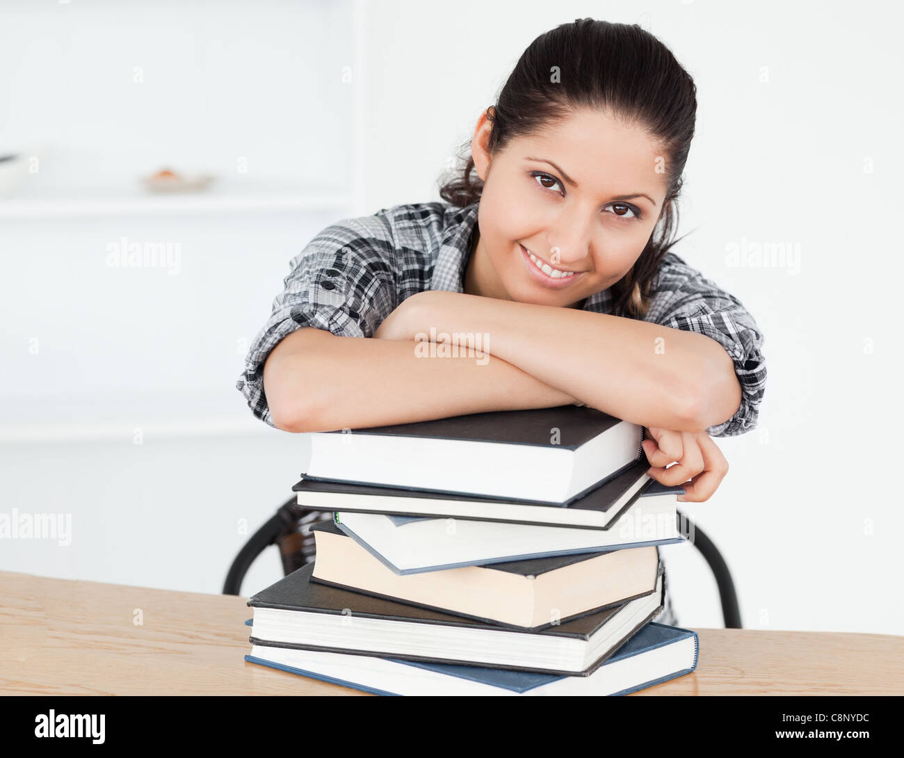 Young student leaning on books Stock Photo - Alamy