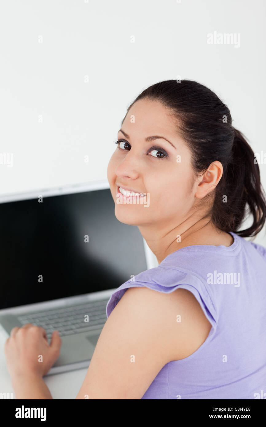 Cheerful young woman sitting at laptop Stock Photo - Alamy