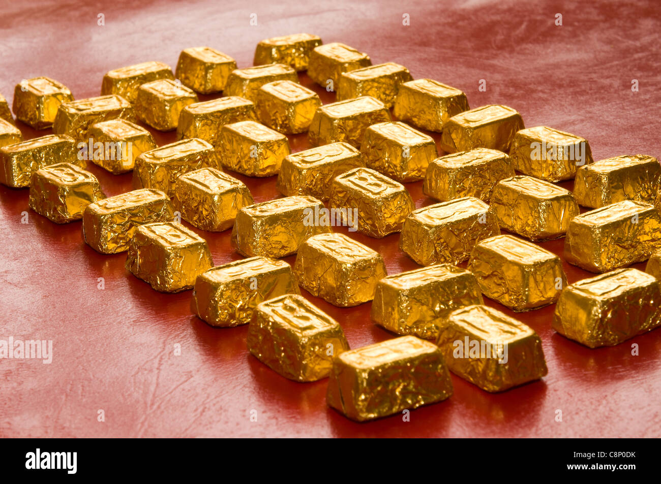 Goldwrapped chocolates in studio setting Stock Photo Alamy