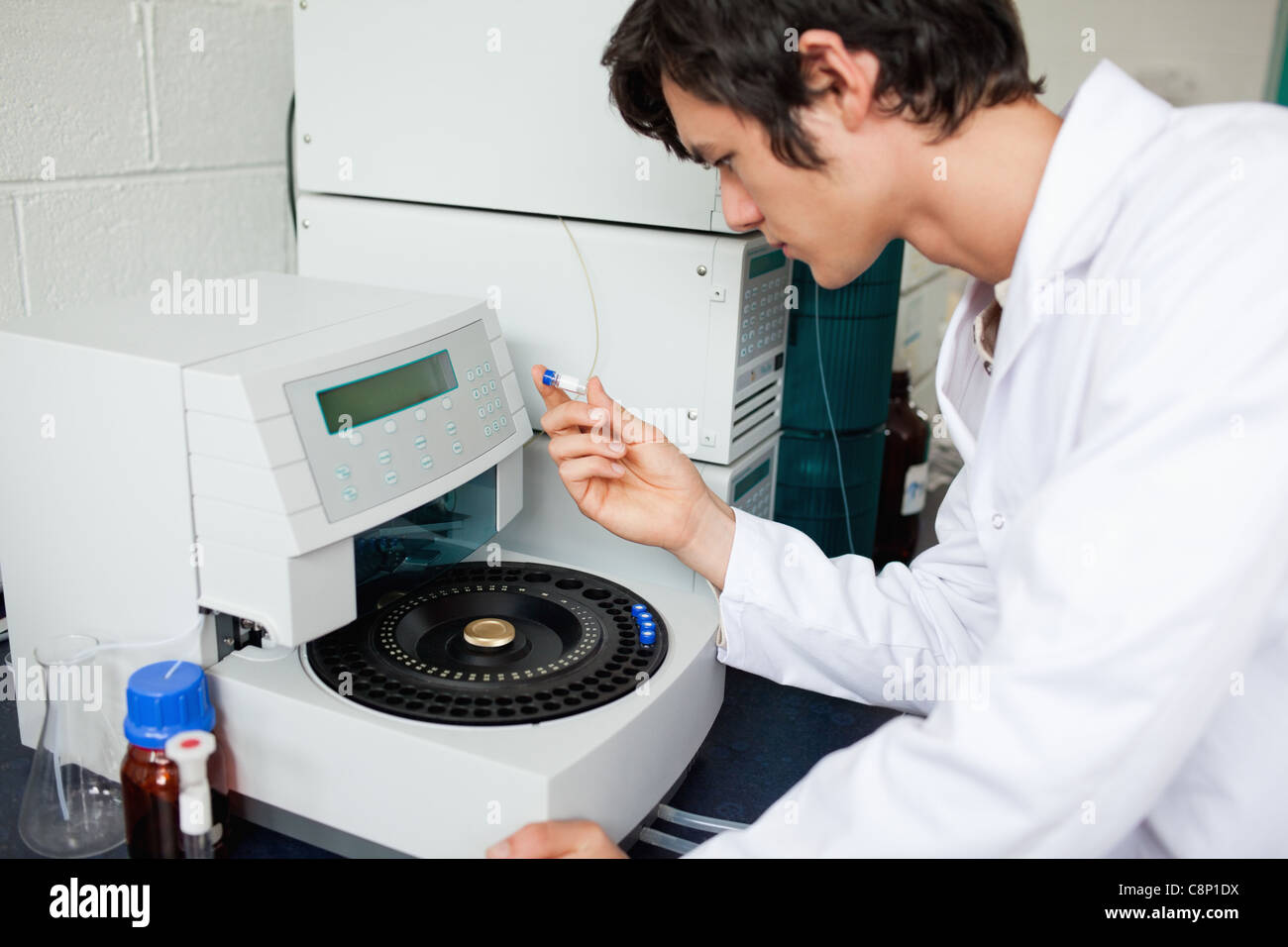 Young chemistry student using a centrifuge Stock Photo