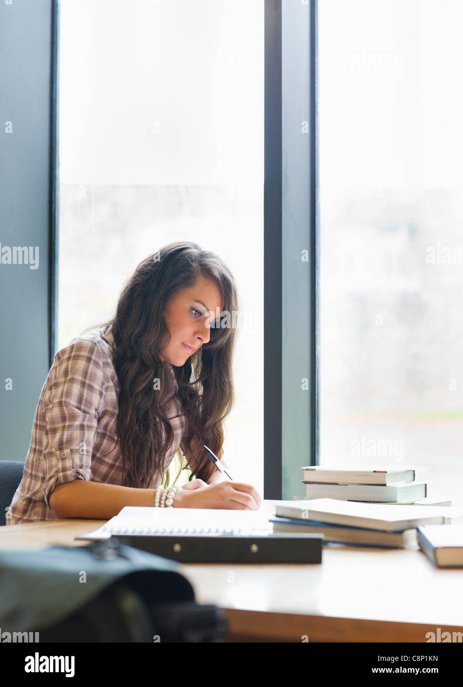 Portrait of a serious student writing Stock Photo