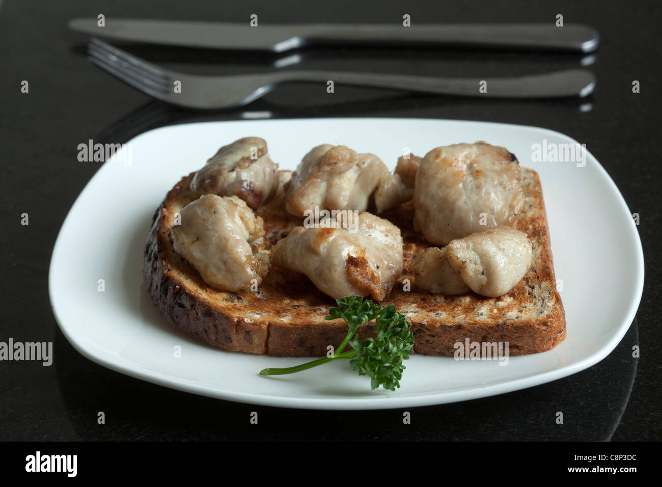 Cooked Sweetbreads on Toast -  -  An example of the strange or weird food eaten by people around the world Stock Photo
