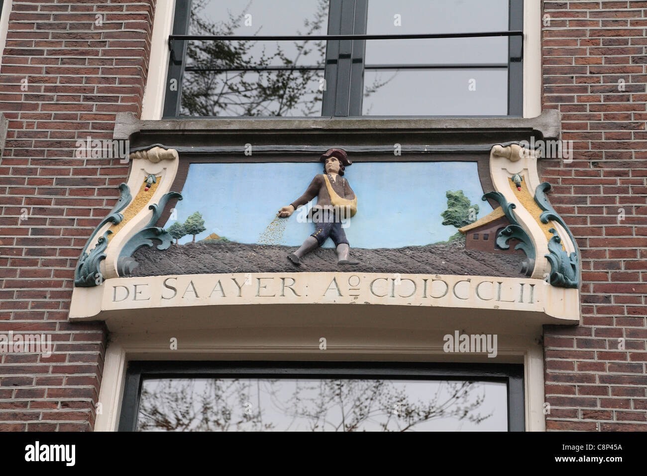 House sign in Jordaan Relief ornate depicting a man sowing seed on ploughed field De Saayer sower Amsterdam Holland Netherlands Stock Photo