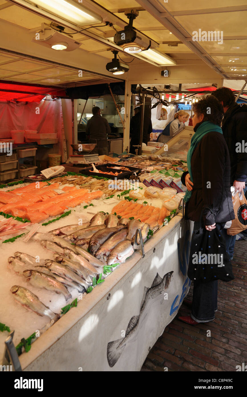 Dutch woman buying fresh fish from a market stall in the  Noordermarkt Jordaan district of Amsterdam Holland Netherlands Stock Photo