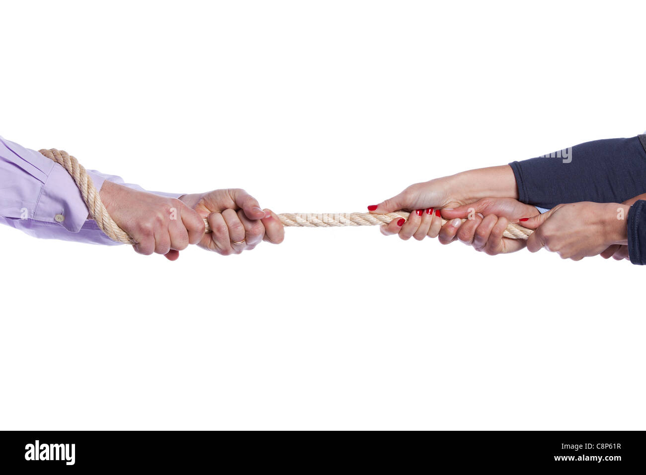 Group of woman hands pulling a rope competing with a man (selective focus) Stock Photo