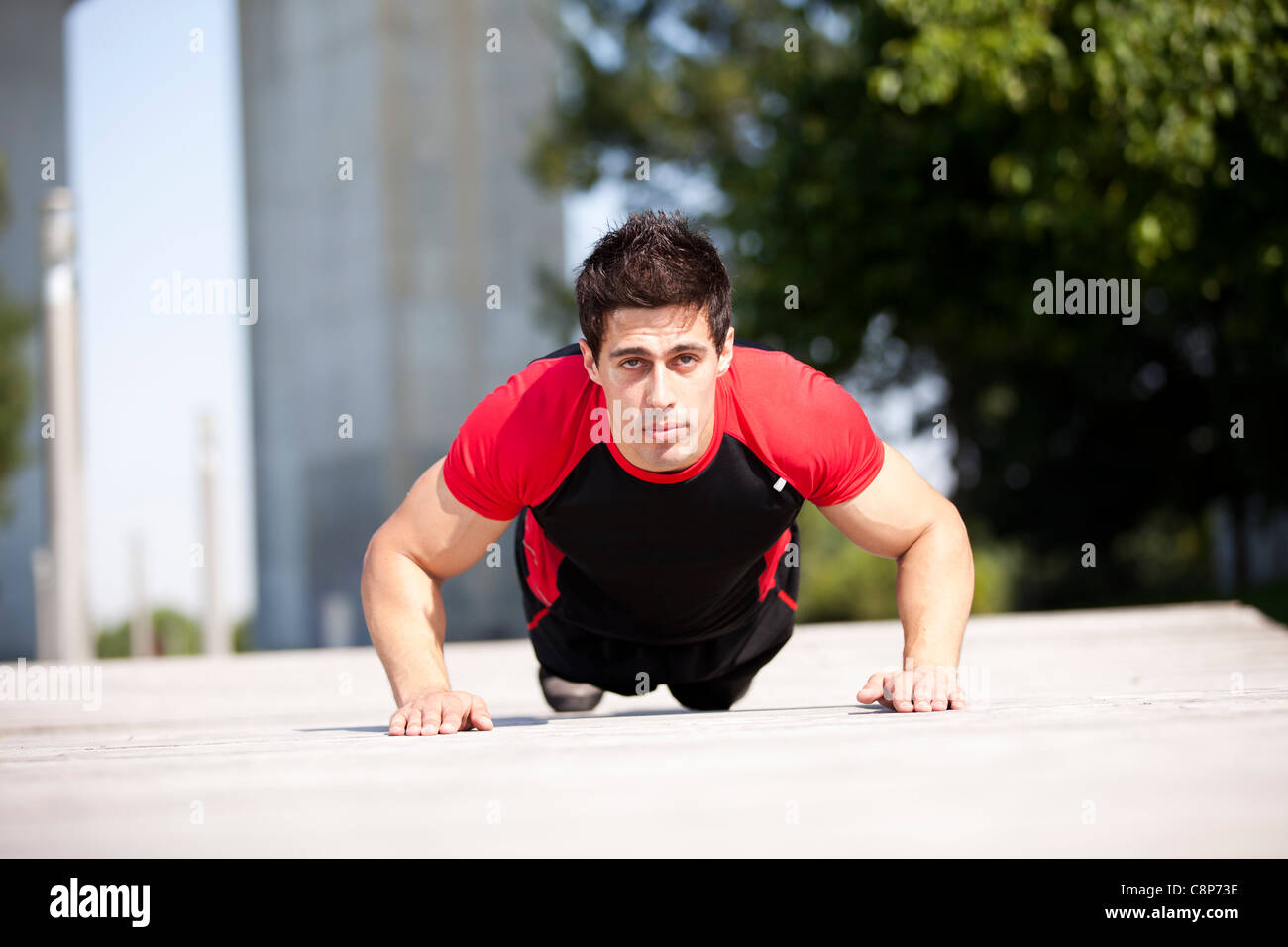 Athlete man at the city park making some pushup Stock Photo - Alamy