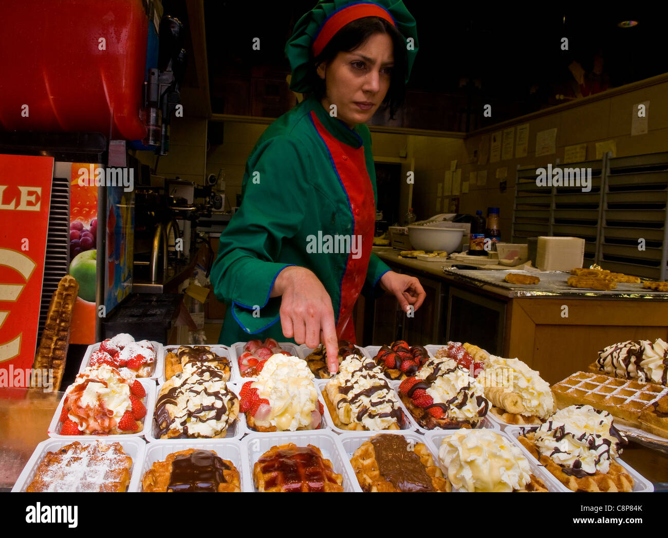 Unidentified waffle seller in a typical waffle stand in Brussels