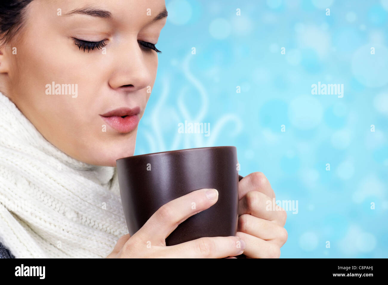 Young woman drinking hot beverage on cold winter day Stock Photo Alamy