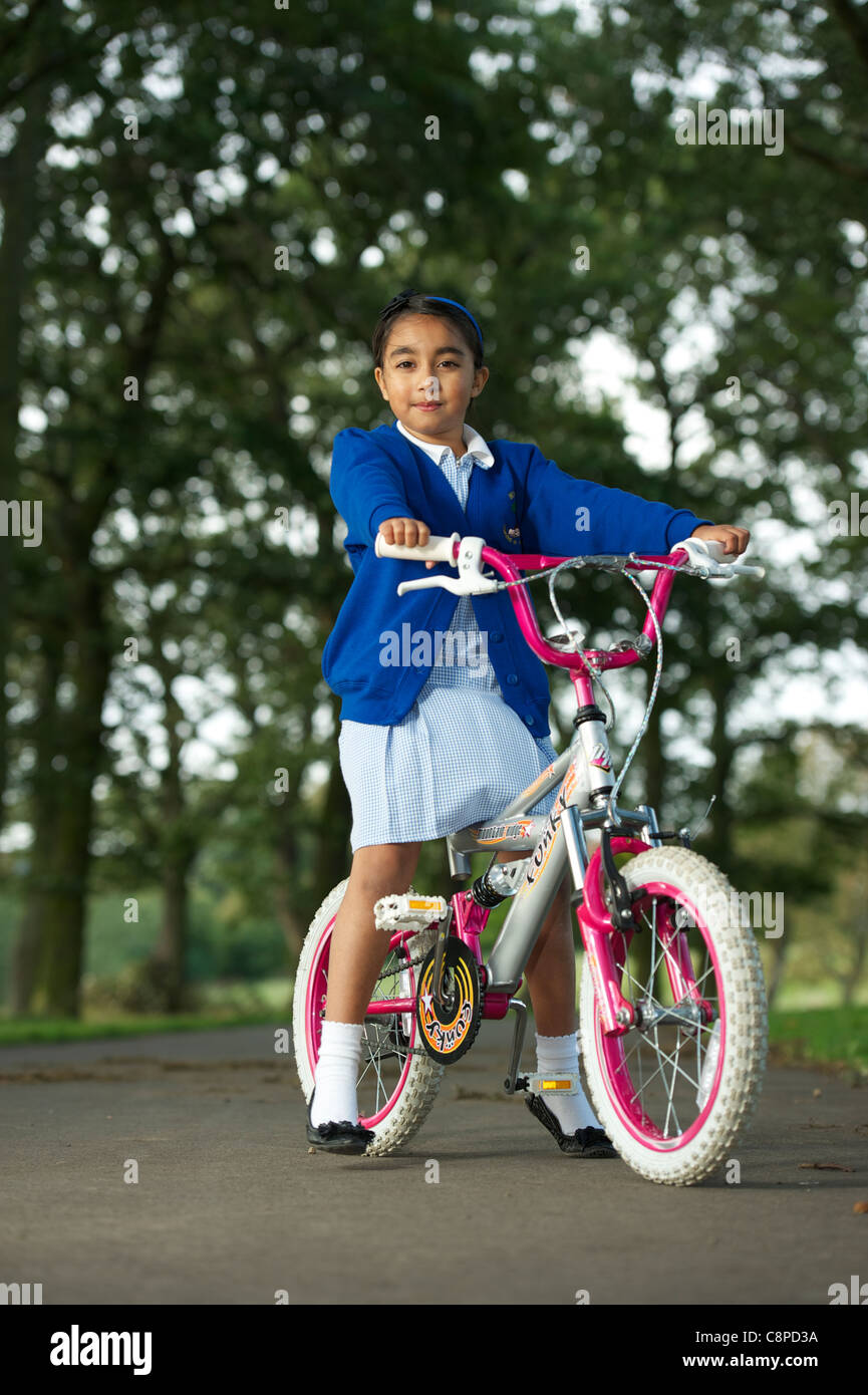 Girl cycling school uniform hi res stock photography and images Alamy