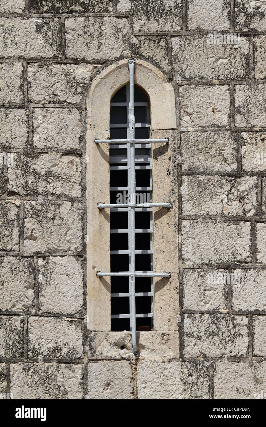 Vrboska on Hvar island - old church window with grating and iron bar Stock Photo