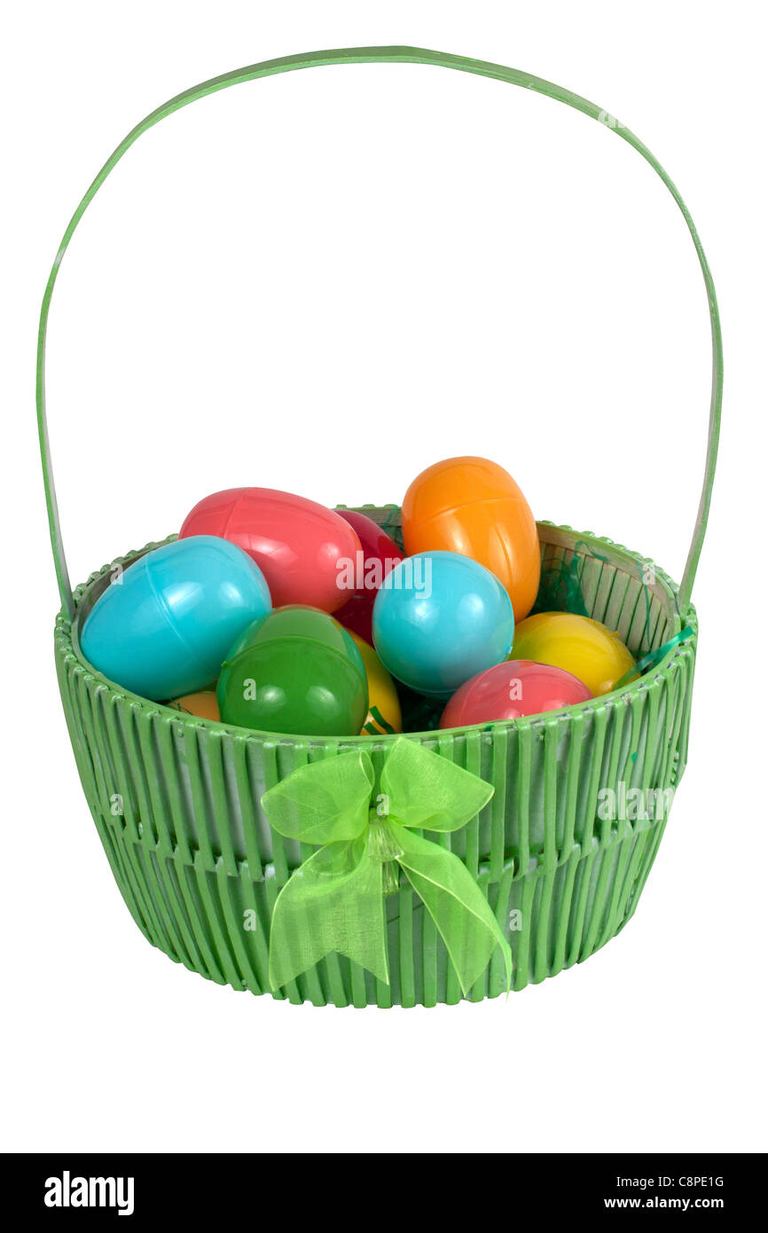 A green Easter basket with plastic eggs isolated on white Stock Photo