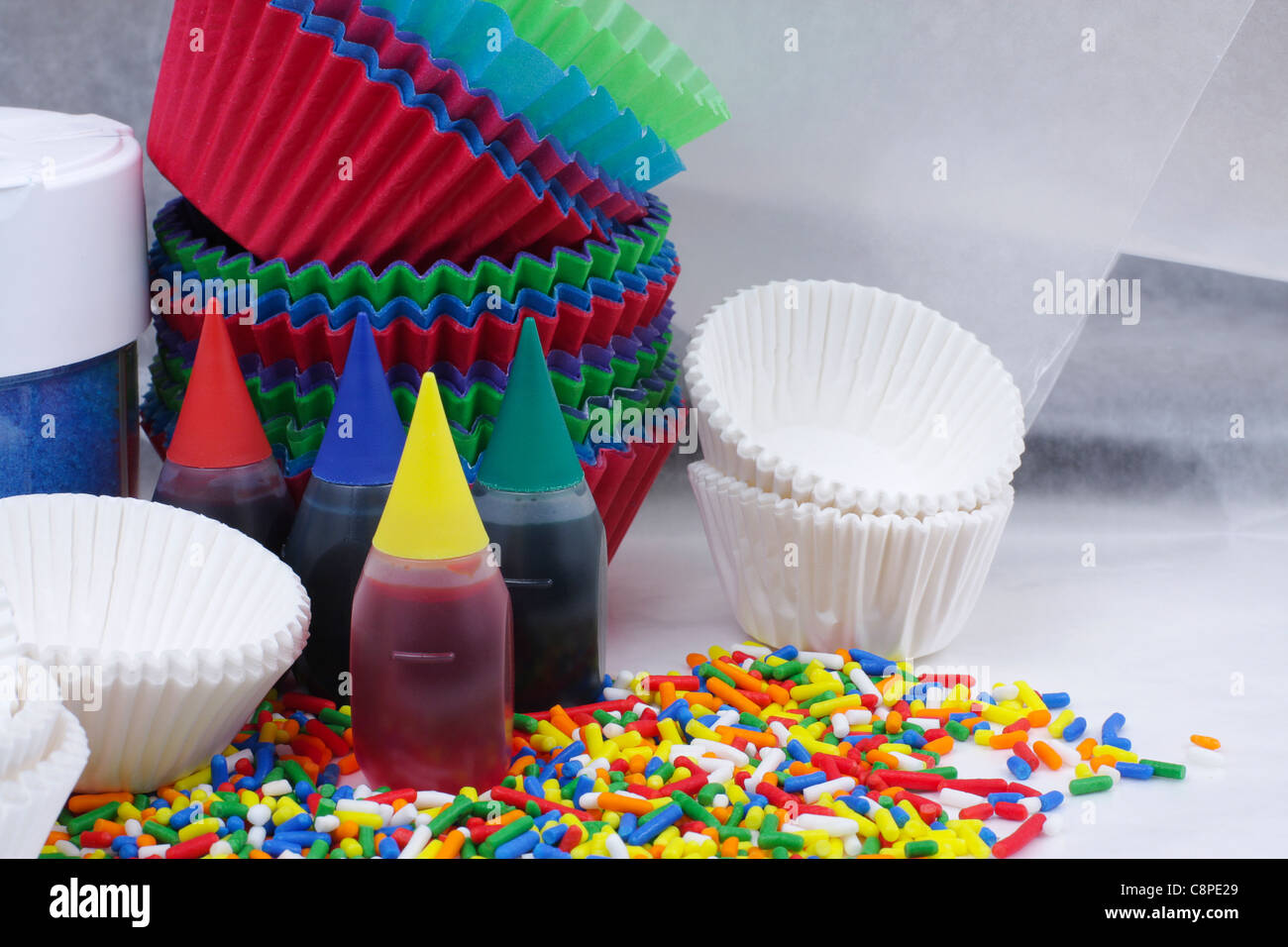 Food coloring, sprinkles and cups for decorating cupcakes Stock Photo