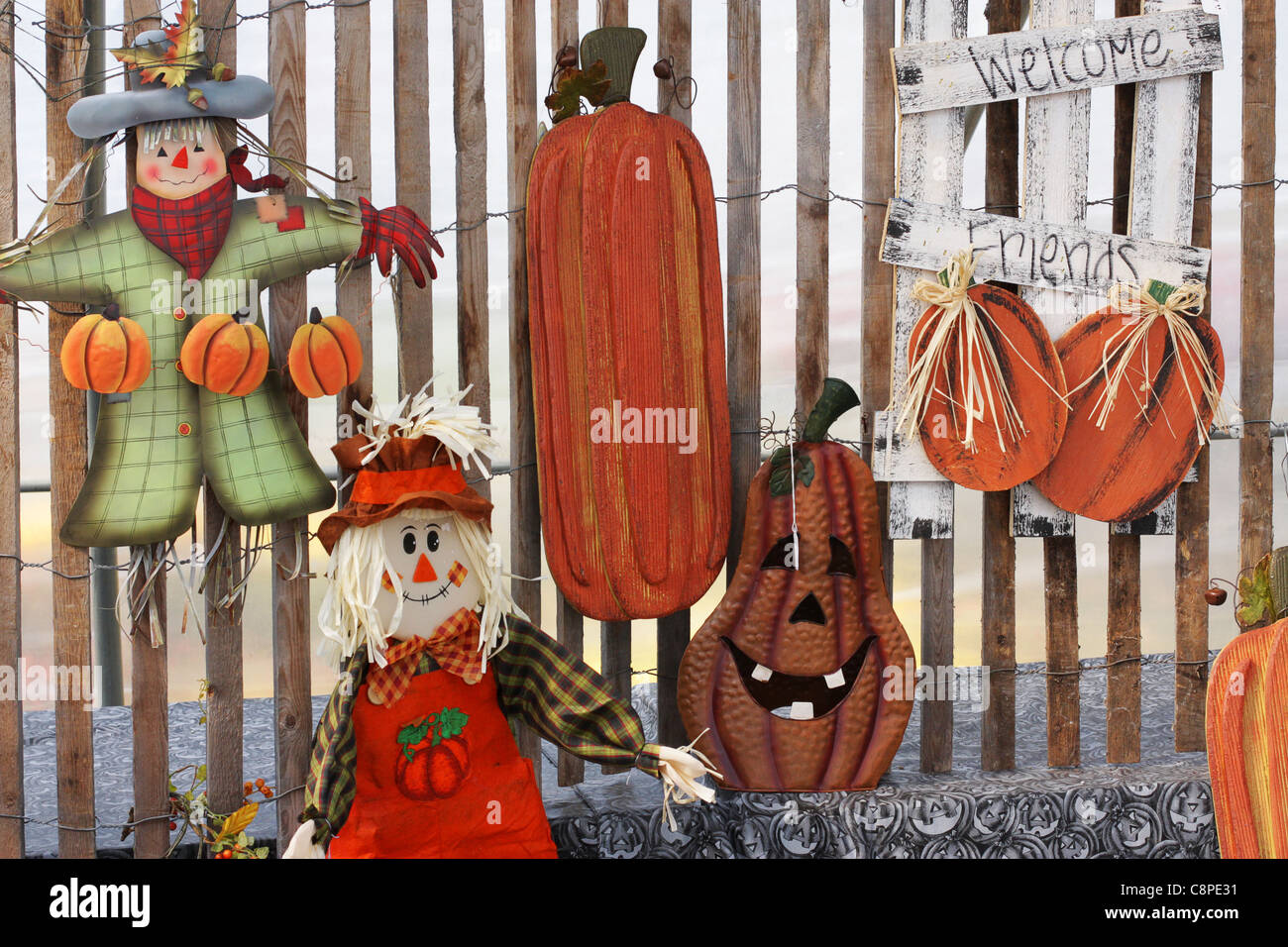 Display of seasonal autumn crafts including scarecrows and pumpkins Stock Photo