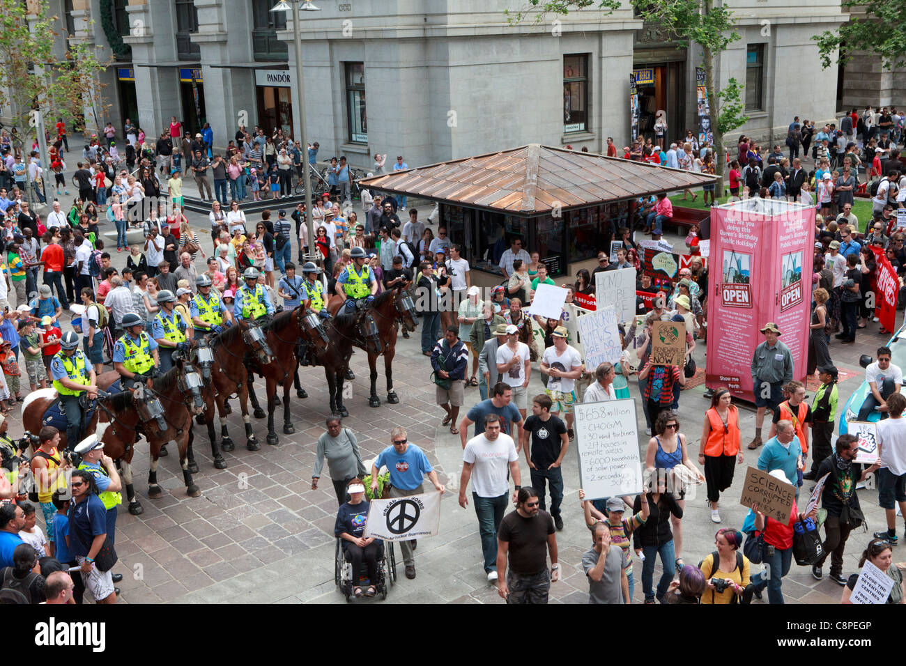 Occupy Perth protesters march past mounted police. The protest was held to coincide with the start of CHOGM 2011 Stock Photo