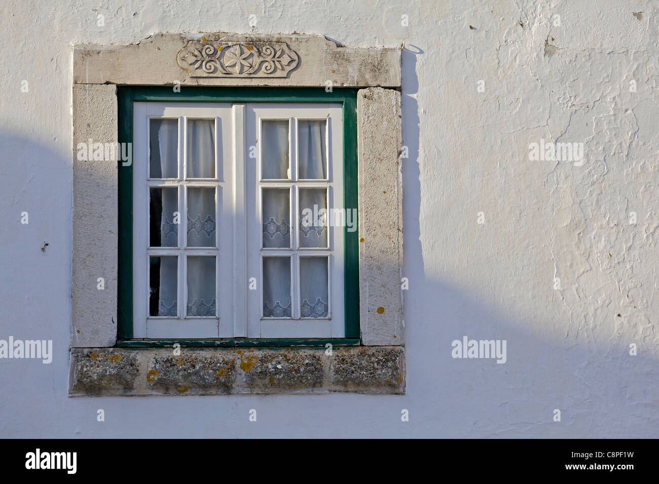 Ornate Carved Stone Window of the Medieval Village of Obidos Stock Photo