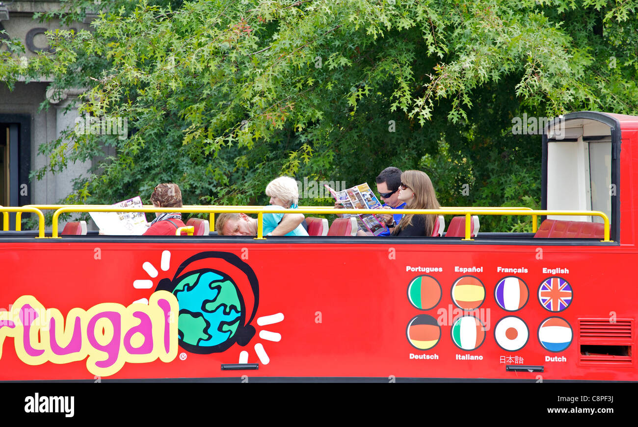 Tourists Riding on a Red Bus During a Guided Tour Stock Photo
