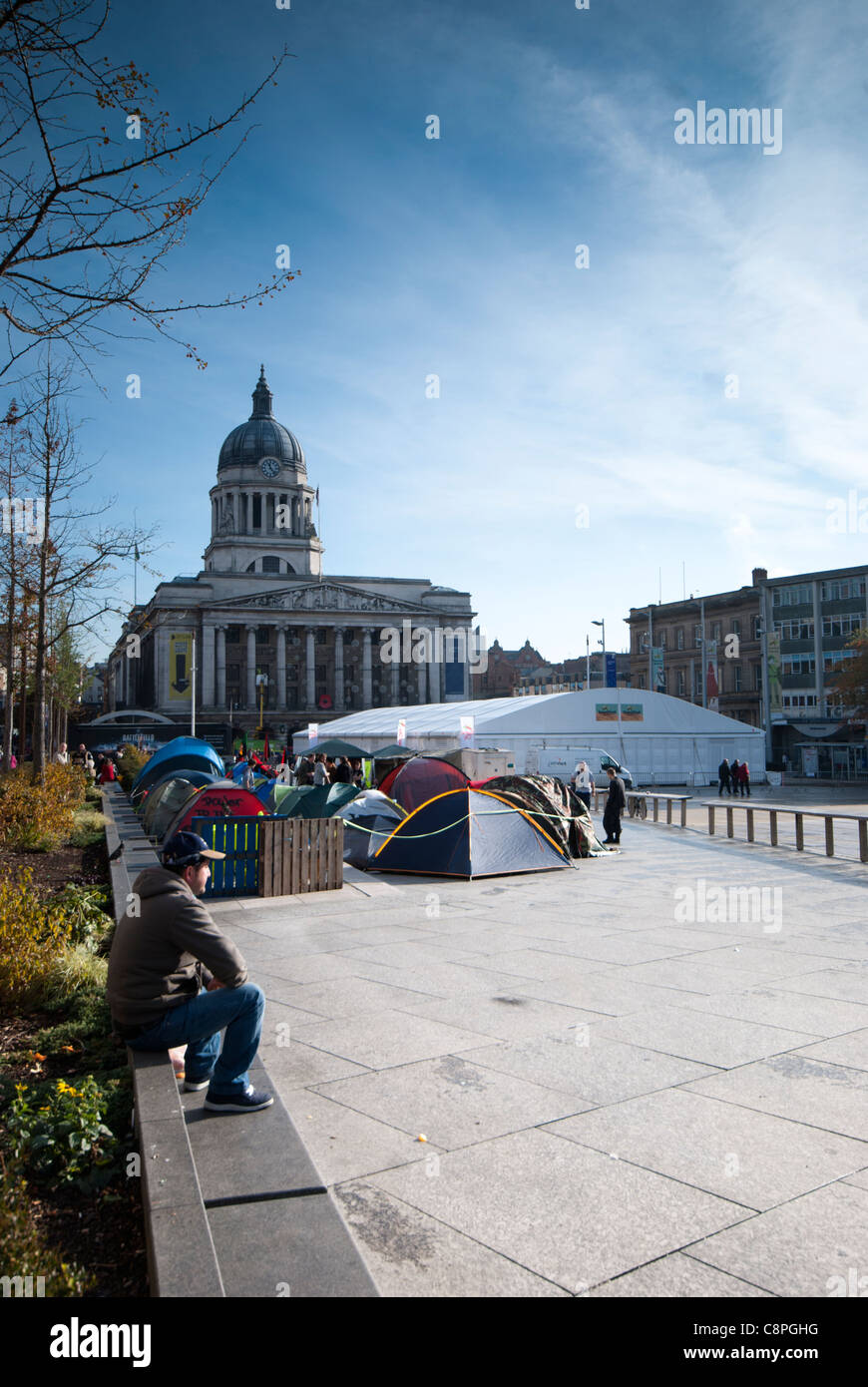 Man looks on outside the protesters camp of the Occupy Movement in the Market Square, Nottingham, England, UK. Stock Photo